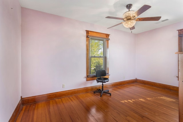 empty room with wood-type flooring and ceiling fan