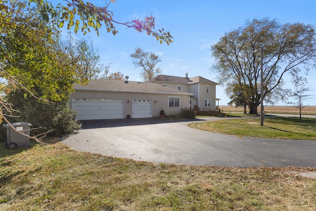 view of front of house featuring a front yard and a garage