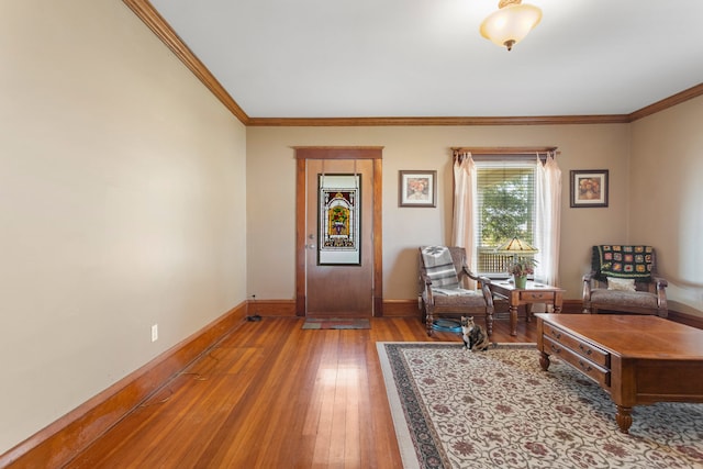 living area with ornamental molding and wood-type flooring