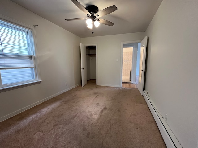 unfurnished bedroom with ceiling fan, light colored carpet, a baseboard radiator, and a closet