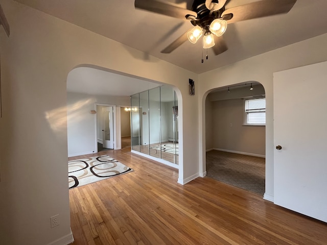 empty room with ceiling fan and hardwood / wood-style floors