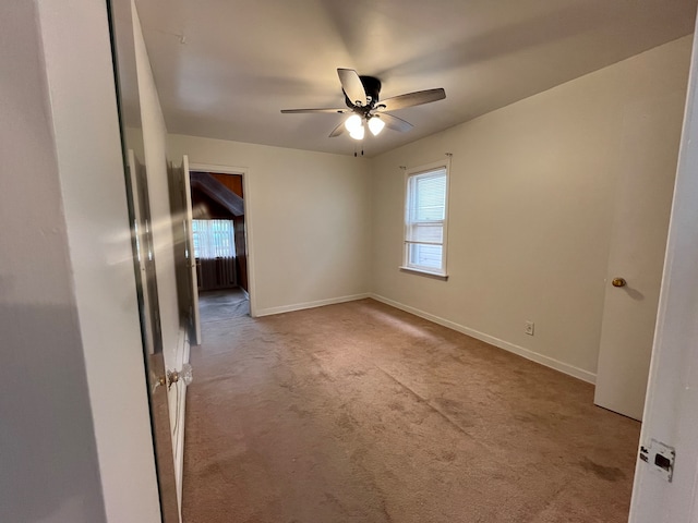 spare room with light carpet and ceiling fan