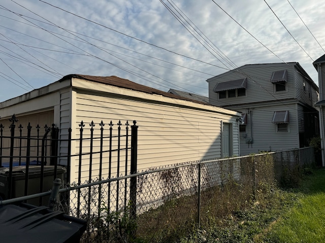 view of side of property with cooling unit and a garage