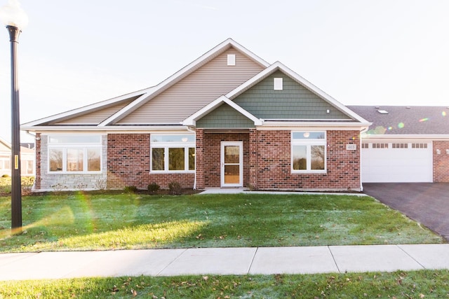 506 Stearn Dr Unit 506, Genoa, IL 60135 - view of front of property with a front lawn, asphalt driveway, an attached garage, and brick siding