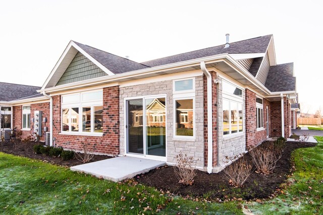 506 Stearn Dr Unit 506, Genoa, IL 60135 - back of house with brick siding, a shingled roof, and stone siding