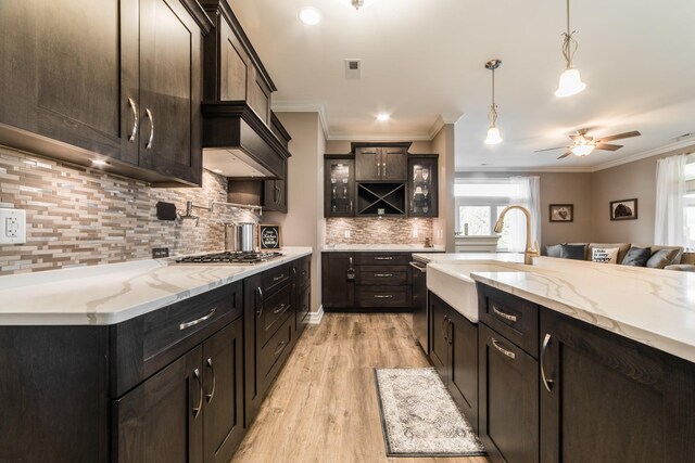 506 Stearn Dr Unit 506, Genoa, IL 60135 - kitchen with ornamental molding, light wood-style floors, stainless steel appliances, backsplash, and glass insert cabinets