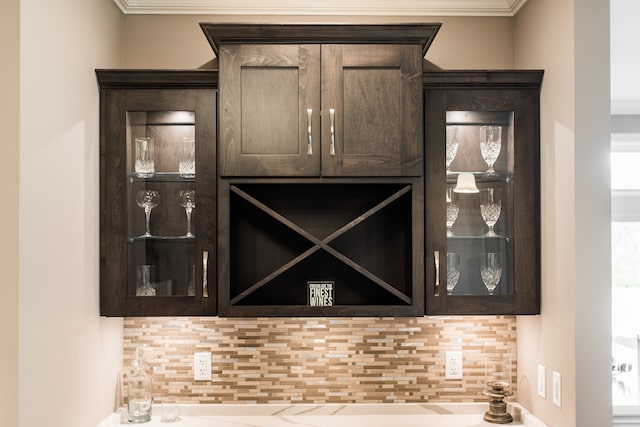 interior details featuring decorative backsplash and ornamental molding