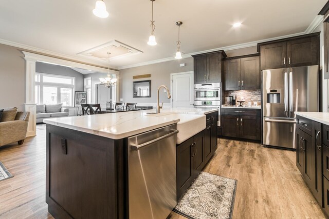 506 Stearn Dr Unit 506, Genoa, IL 60135 - kitchen with stainless steel appliances, ornamental molding, dark brown cabinets, decorative light fixtures, and light wood-type flooring