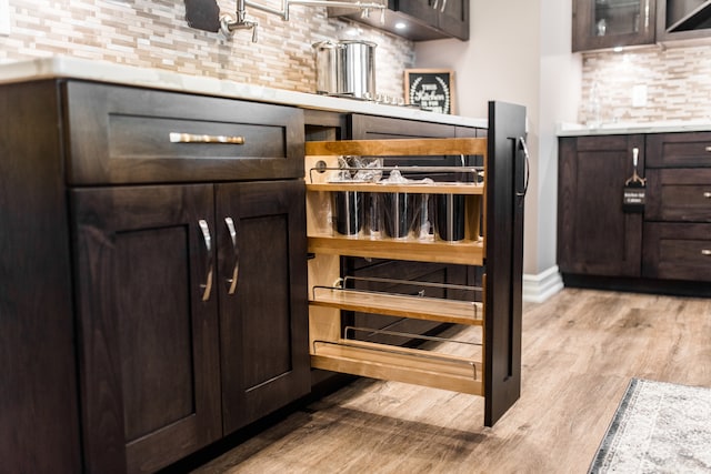 interior space featuring wine cooler, light hardwood / wood-style flooring, and dark brown cabinets