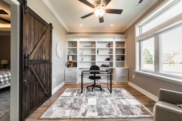 office space with ornamental molding, hardwood / wood-style floors, a barn door, and ceiling fan