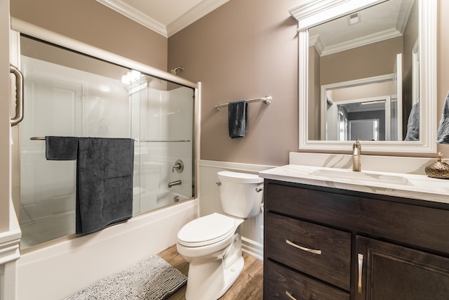 full bathroom with wood-type flooring, combined bath / shower with glass door, toilet, vanity, and crown molding