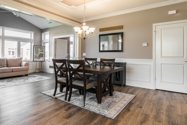 dining area featuring ornamental molding, dark hardwood / wood-style floors, a chandelier, and vaulted ceiling