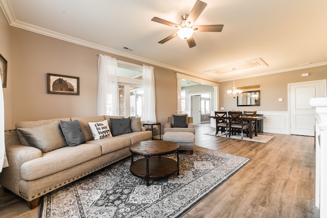 living room featuring ornamental molding, wood-type flooring, and ceiling fan