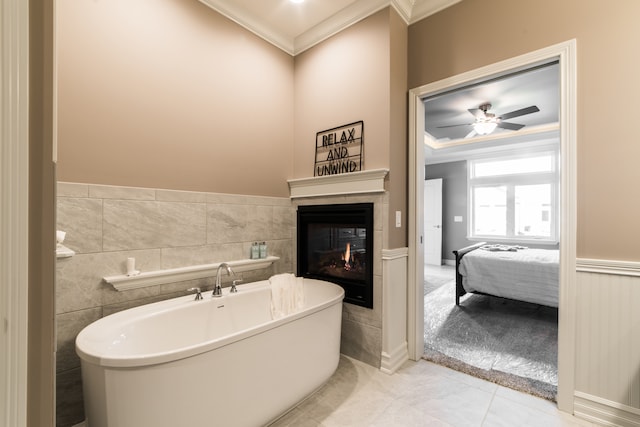 bathroom featuring a bath, crown molding, tile patterned floors, and ceiling fan