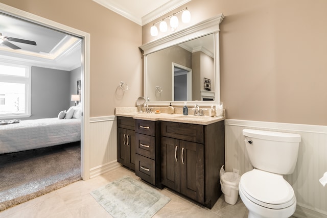 bathroom with vanity, toilet, crown molding, and ceiling fan