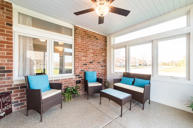 sunroom / solarium featuring ceiling fan