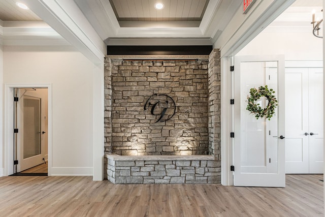 room details featuring wood-type flooring, a tray ceiling, and ornamental molding