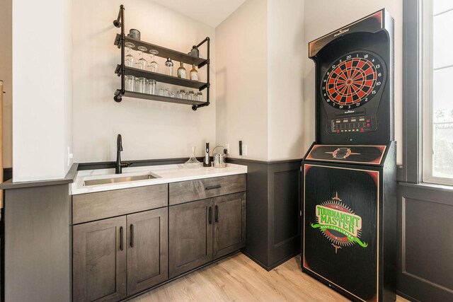 506 Stearn Dr Unit 506, Genoa, IL 60135 - washroom featuring stacked washer and clothes dryer, light wood-style floors, bar with sink, and cabinet space