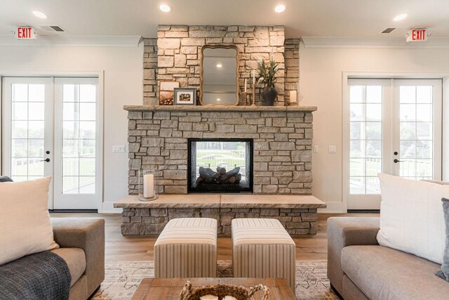 506 Stearn Dr Unit 506, Genoa, IL 60135 - living room featuring crown molding, wood finished floors, french doors, a fireplace, and recessed lighting