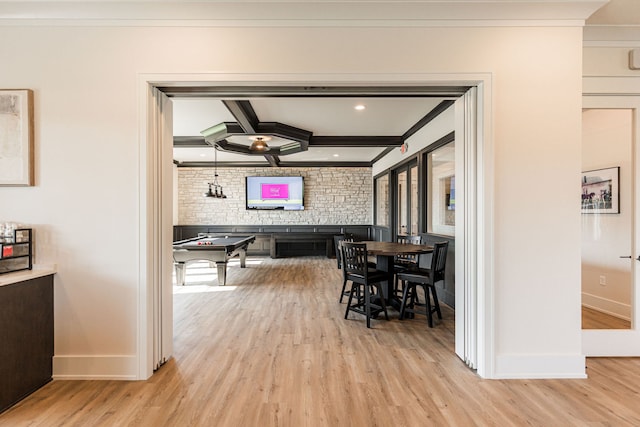 dining room featuring beam ceiling, crown molding, and light hardwood / wood-style flooring