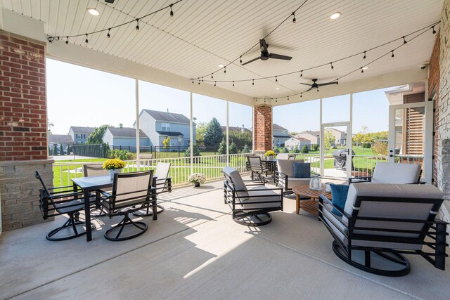 506 Stearn Dr Unit 506, Genoa, IL 60135 - view of patio with outdoor dining area, a ceiling fan, an outdoor living space, and a residential view
