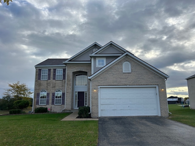 view of front of property featuring a front lawn and a garage