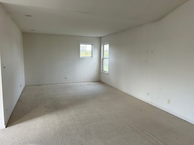 spare room with light colored carpet