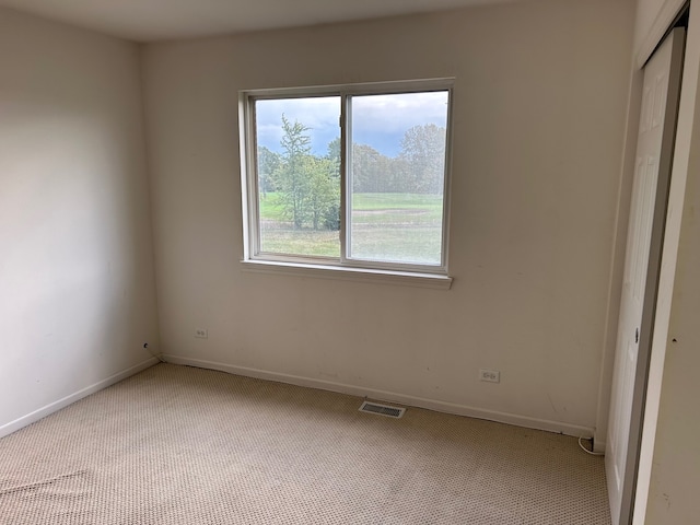 unfurnished bedroom featuring light carpet