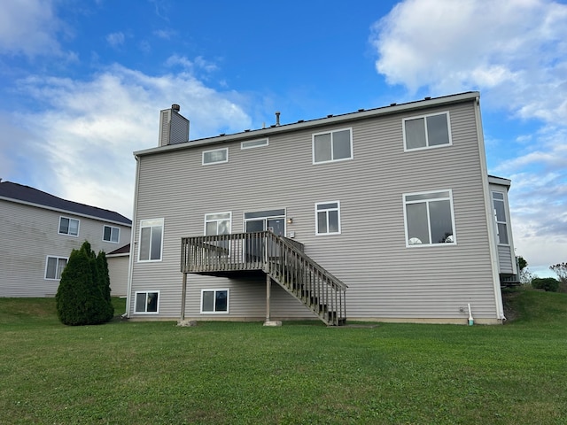 back of house with a yard and a wooden deck