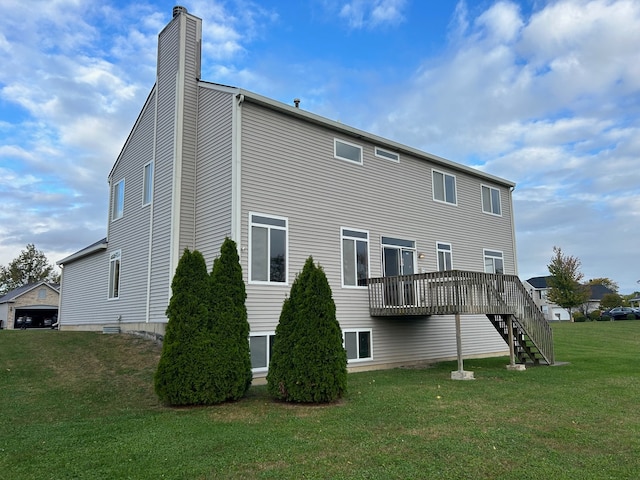 back of property with a yard and a deck