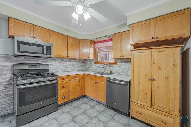 kitchen with sink, appliances with stainless steel finishes, ornamental molding, ceiling fan, and decorative backsplash