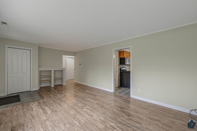 unfurnished living room with light wood-type flooring and crown molding