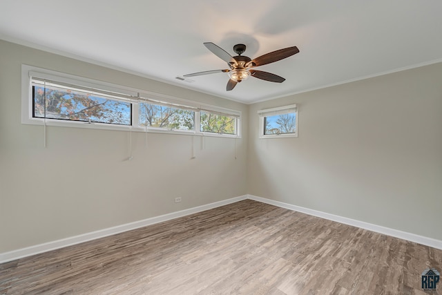 unfurnished room with ceiling fan, wood-type flooring, and crown molding