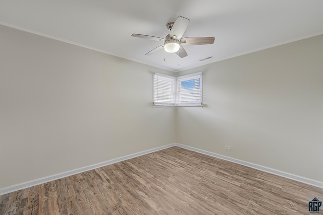 unfurnished room with ornamental molding, hardwood / wood-style floors, and ceiling fan