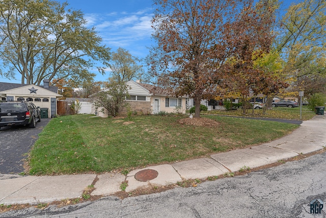 obstructed view of property featuring a front lawn