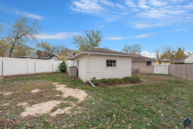 rear view of property featuring a yard