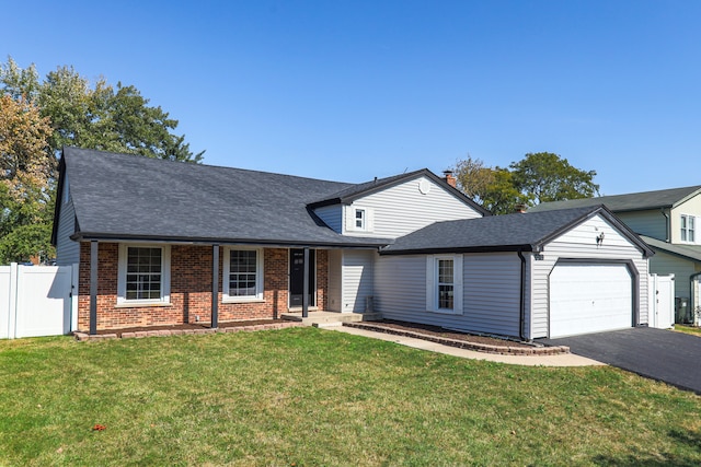 view of front of house with a garage and a front lawn