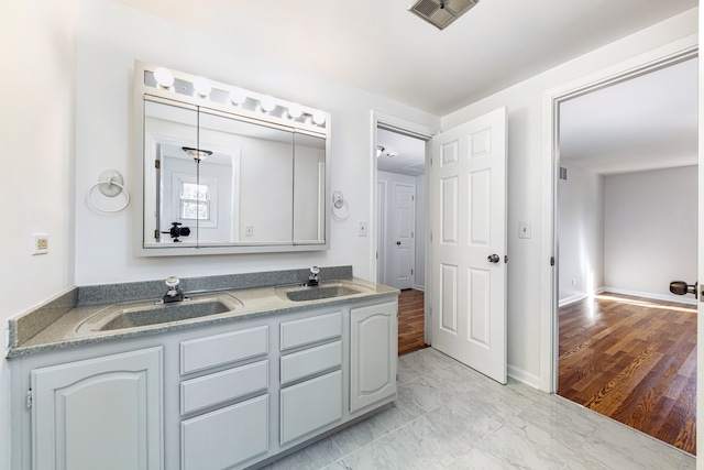 bathroom with vanity and hardwood / wood-style flooring