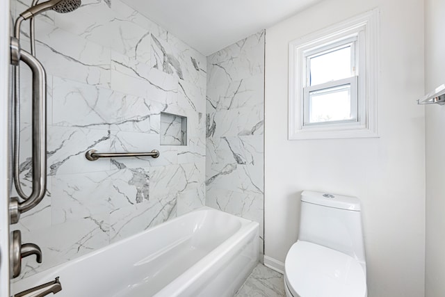 bathroom featuring toilet and tiled shower / bath