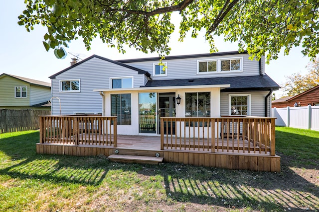 back of house with a yard and a deck