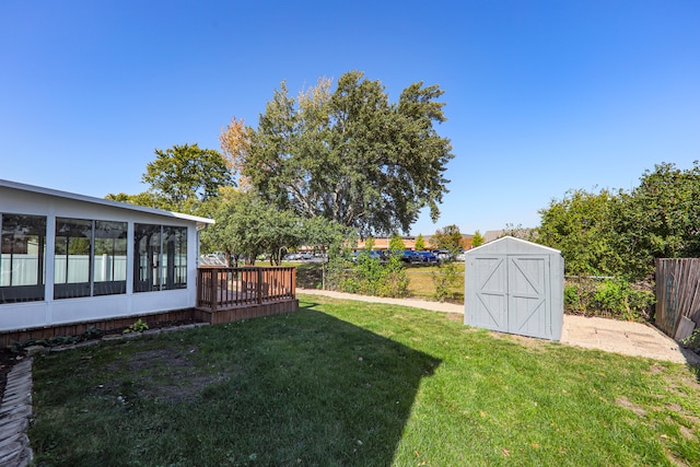 view of yard with a storage unit and a sunroom