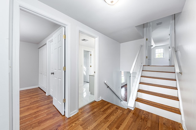 stairway with hardwood / wood-style floors