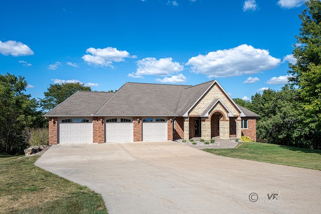 view of front facade with a garage and a front lawn