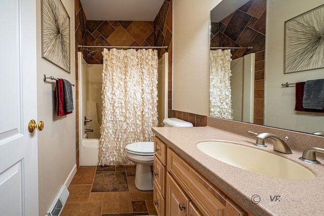 full bathroom with vanity, shower / bath combo with shower curtain, and toilet