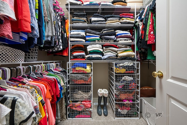 walk in closet with carpet floors