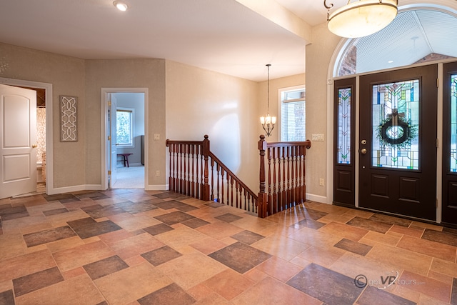 foyer with a notable chandelier