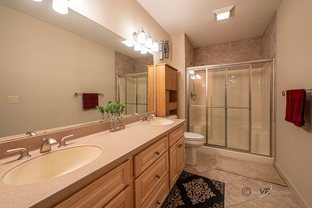 bathroom featuring walk in shower, tile patterned floors, vanity, and toilet