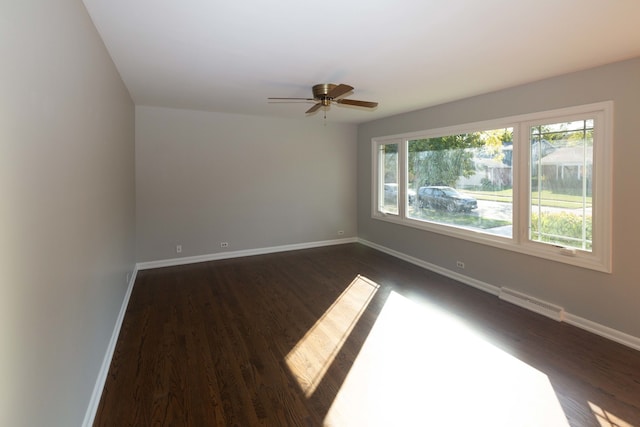 spare room featuring ceiling fan and dark hardwood / wood-style flooring