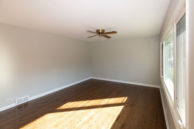 spare room featuring dark hardwood / wood-style floors and ceiling fan