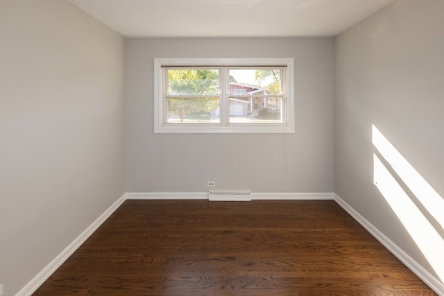 spare room featuring dark hardwood / wood-style flooring